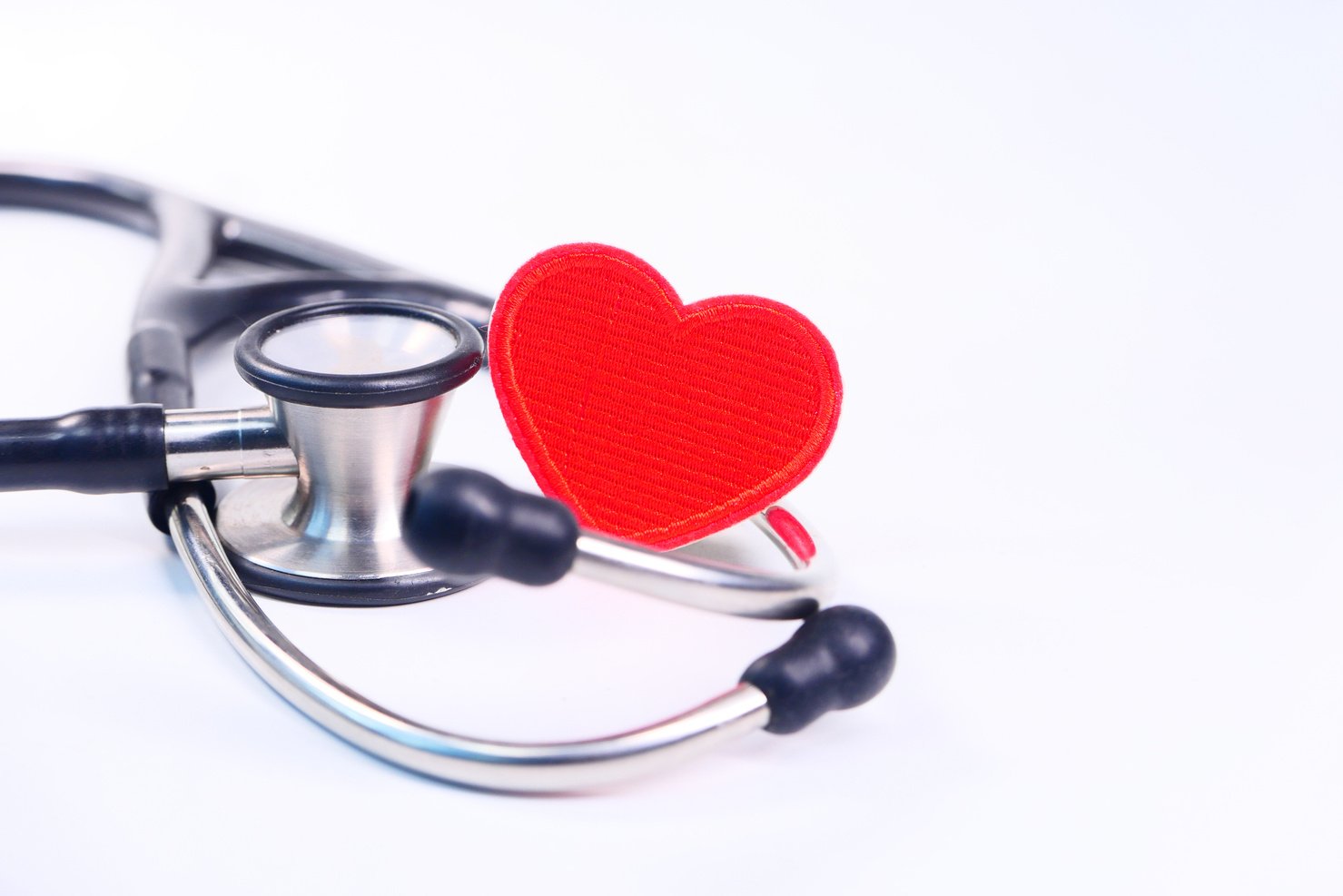 Heart Shape Symbol and Stethoscope on White Background